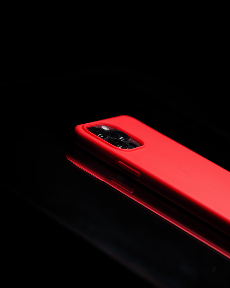 Profile view of red MagBak case on dark mirror