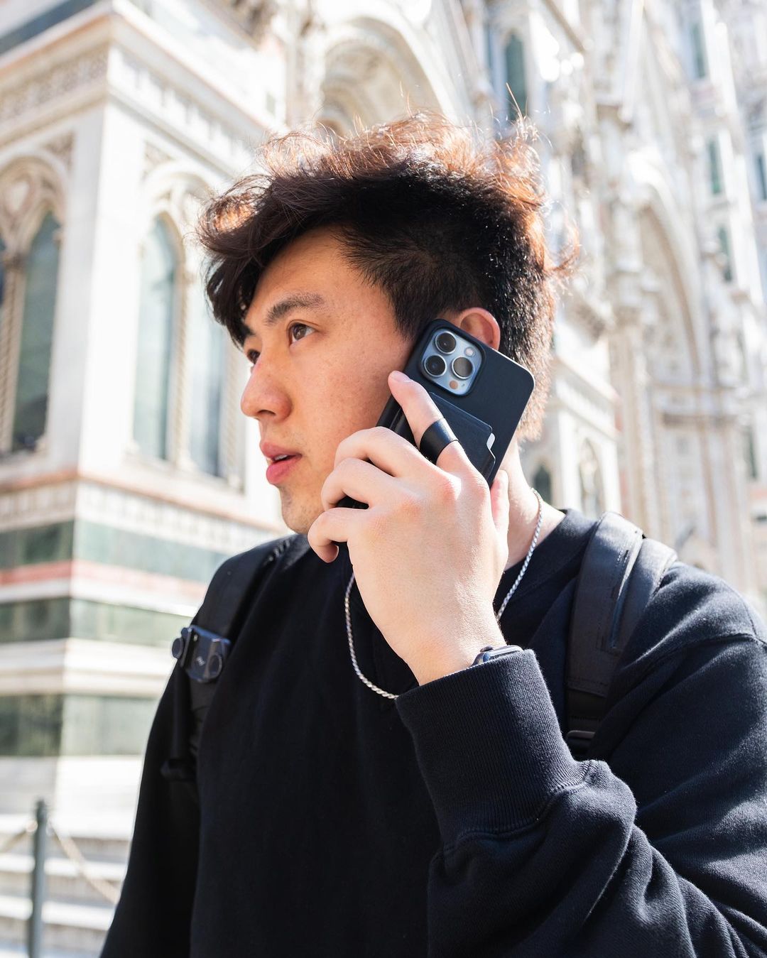 Showing MagBak Wallet finger loop to securely hold iPhone while making a phone call.