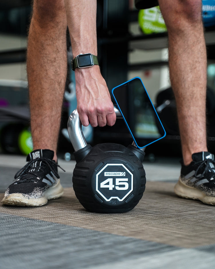 iPhone with MagBak case mounted on kettlebell while performing exercises