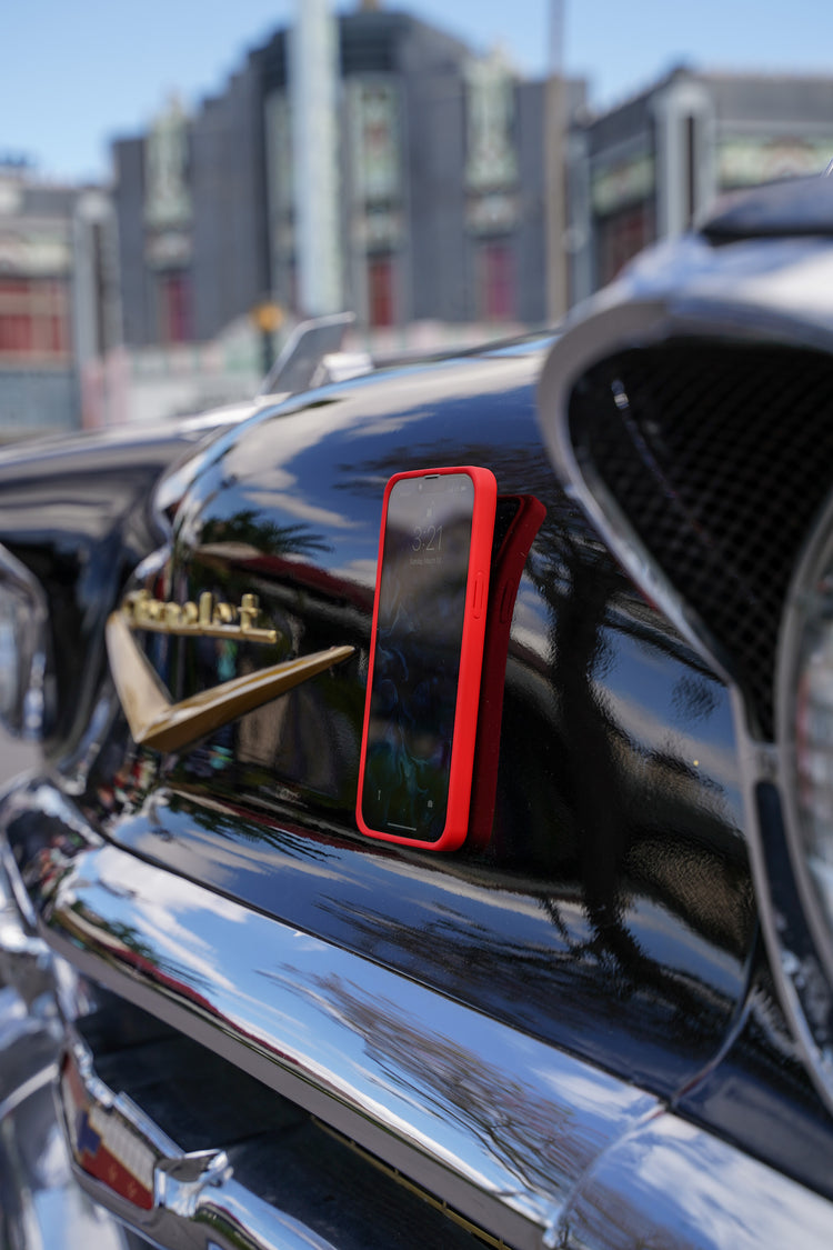 iPhone with MagBak case mounted on a classic car front hood