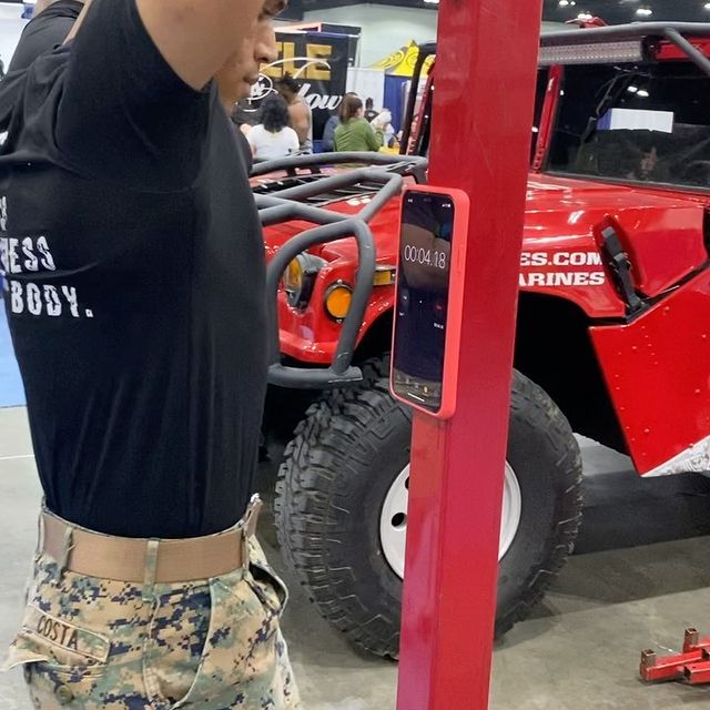 Army soldier timing pull ups using iPhone with MagBak case mounted on pull up bar frame. 