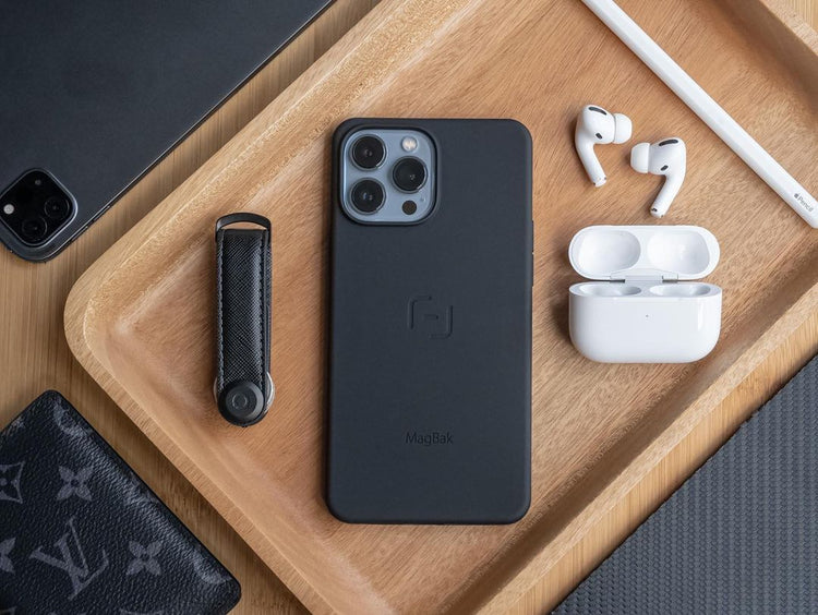 Assortment of everyday carry products surrounding an iPhone with a MagBak case 