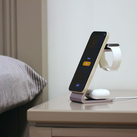 MultiCharger charging 3 devices sitting on night stand. 