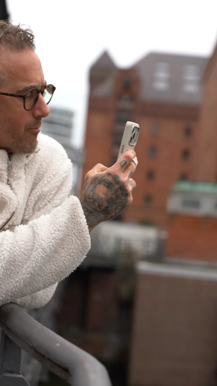Nicolas Majou using a beige MagBak Elite Case for iPhone 17 Pro outdoors