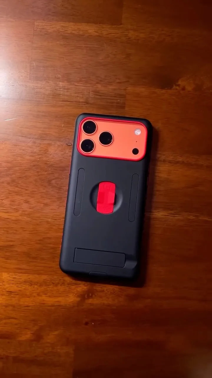 Black and red MagBak Elite Case for iPhone 17 Pro Max on a wooden desk